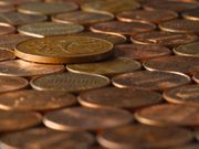 A variety of coins considered to be lower-value, including an Irish 2p piece and many US pennies.